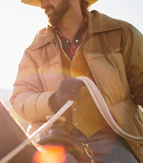 Authentic Oklahoma heritage - A cowboy riding a horse representing Land Run Distillery's traditional values